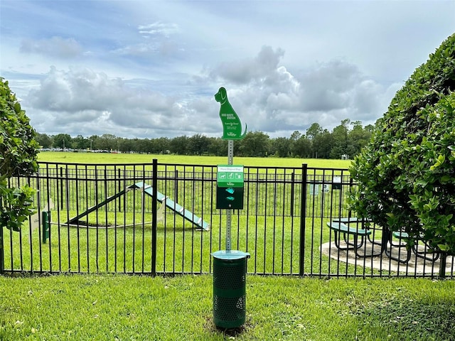 surrounding community featuring fence and a yard