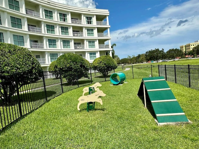 view of home's community featuring fence and a lawn