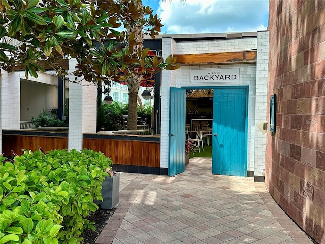 doorway to property with brick siding