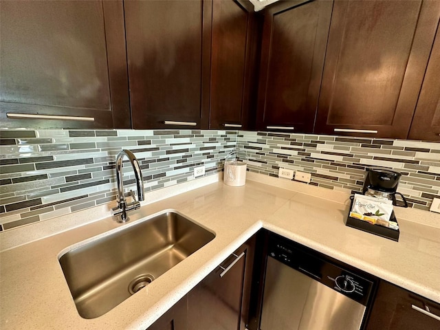 kitchen featuring decorative backsplash, light countertops, a sink, and stainless steel dishwasher