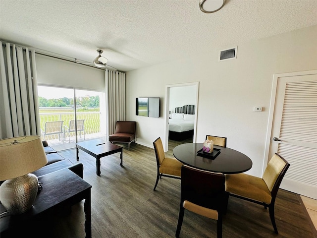 interior space with visible vents, a textured ceiling, and wood finished floors