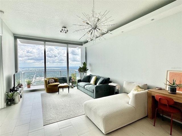 tiled living room with a wall of windows, a chandelier, and a textured ceiling