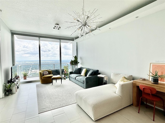 living room featuring light tile patterned flooring, a textured ceiling, an inviting chandelier, and floor to ceiling windows