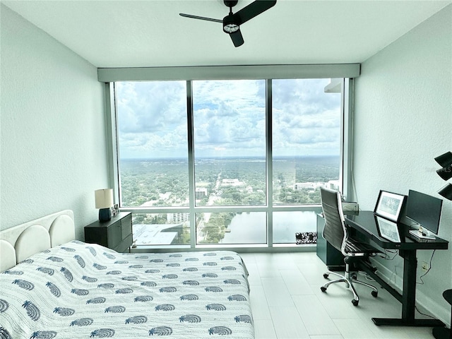 bedroom featuring expansive windows, ceiling fan, and hardwood / wood-style floors