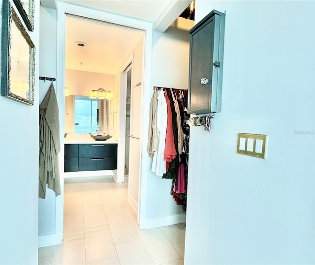 hall featuring light tile patterned floors