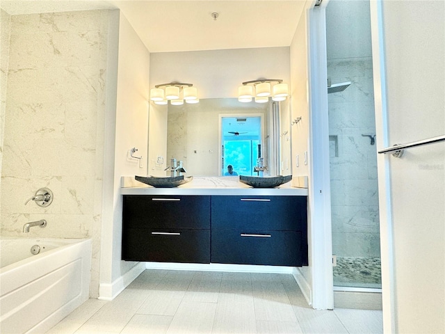 bathroom featuring plus walk in shower, tile patterned flooring, and vanity