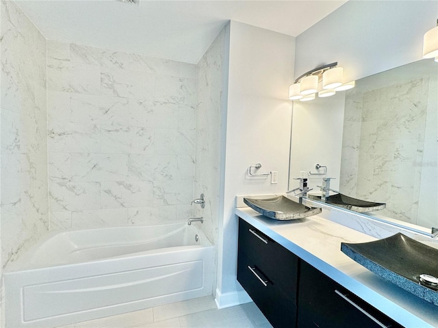 bathroom featuring tile patterned floors, vanity, and tiled shower / bath combo