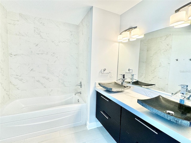 bathroom featuring tile patterned flooring, vanity, and tiled shower / bath combo