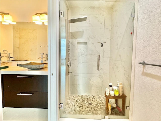 bathroom with a shower with door and vanity