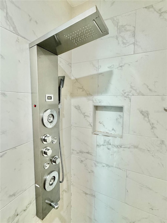 interior details with a tile shower