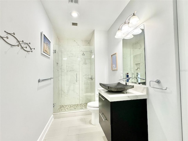 bathroom with tile patterned flooring, an enclosed shower, vanity, and toilet