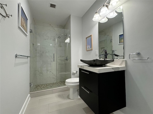 bathroom featuring tile patterned floors, a shower with shower door, vanity, and toilet