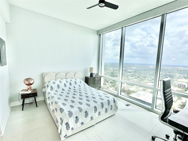 tiled bedroom featuring ceiling fan and floor to ceiling windows