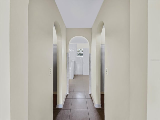 hallway with tile patterned flooring