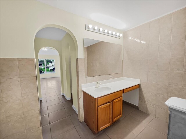 bathroom featuring tile patterned flooring and tile walls