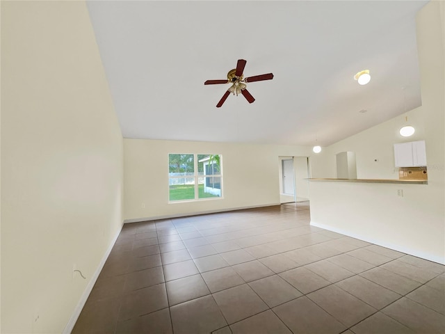 unfurnished living room with ceiling fan, vaulted ceiling, and light tile patterned flooring