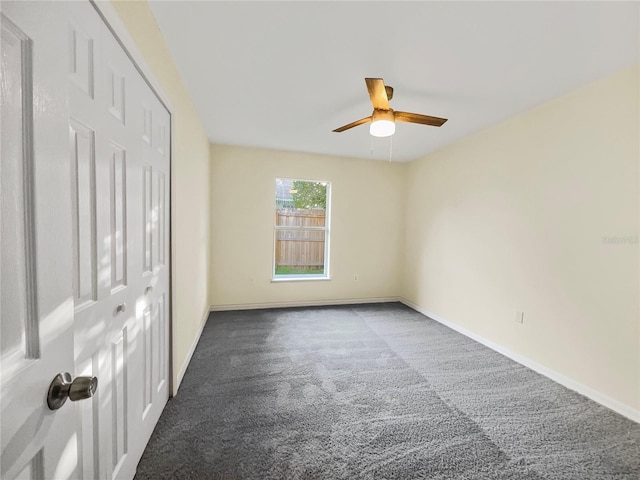 carpeted empty room with ceiling fan