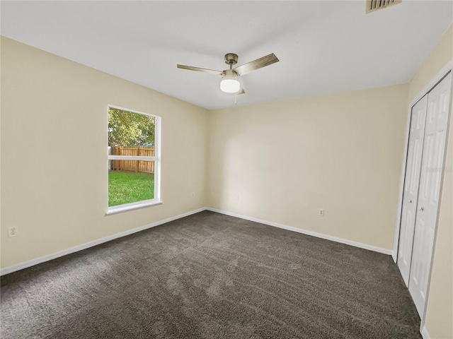 unfurnished bedroom featuring ceiling fan, a closet, and carpet flooring