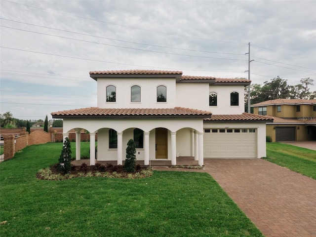 mediterranean / spanish house with a front yard and covered porch