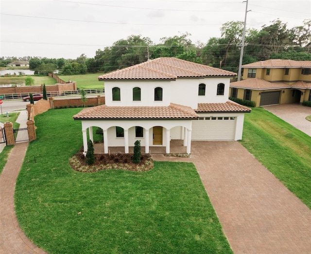 mediterranean / spanish-style home with a garage and a front yard