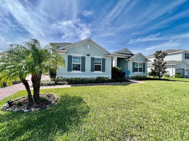 single story home featuring a front lawn