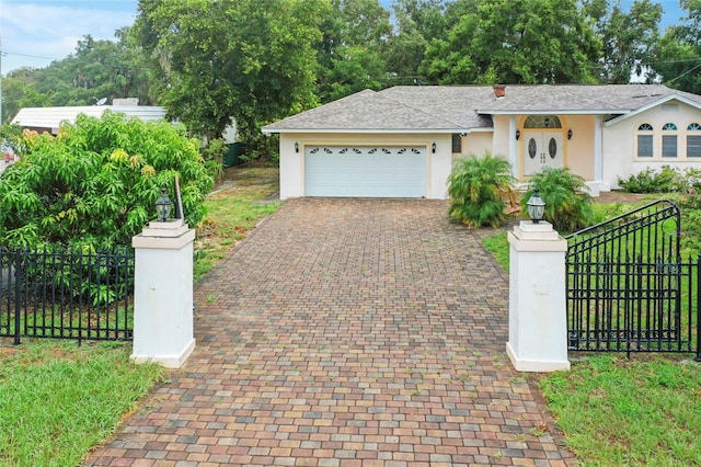 single story home with stucco siding, an attached garage, decorative driveway, and fence