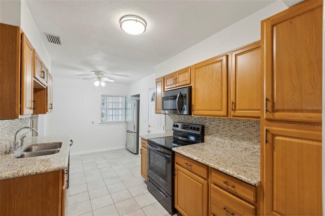 kitchen featuring sink, tasteful backsplash, appliances with stainless steel finishes, and ceiling fan