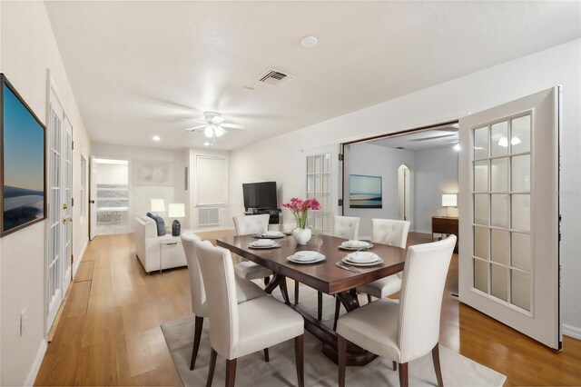 dining room with light hardwood / wood-style floors, french doors, and ceiling fan