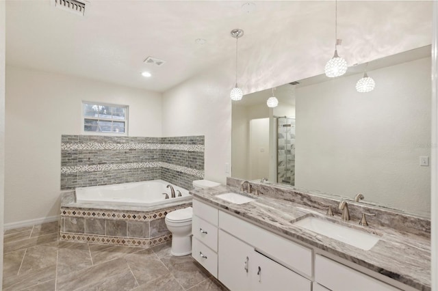 bathroom with tiled bath, tile patterned floors, toilet, and vanity