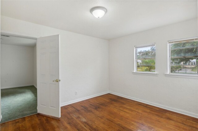 empty room featuring dark carpet