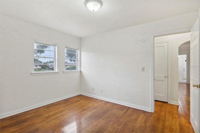 spare room featuring wood-type flooring