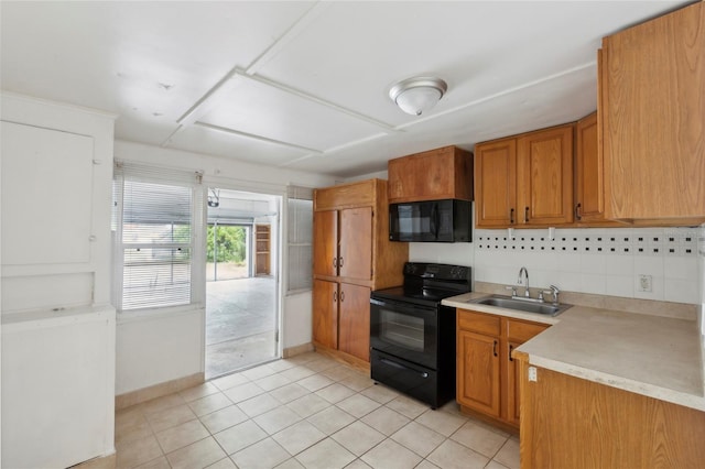 kitchen with sink, decorative backsplash, light tile patterned flooring, and black appliances