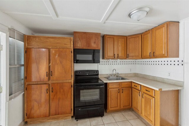 kitchen with sink, light tile patterned floors, black appliances, and backsplash