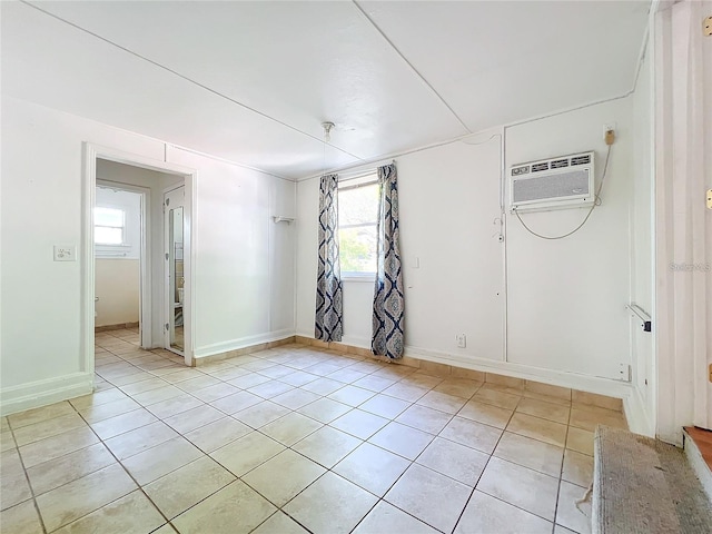 tiled spare room featuring a wall mounted air conditioner