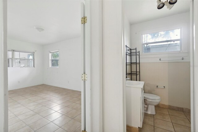 bathroom with tile patterned flooring, vanity, and toilet