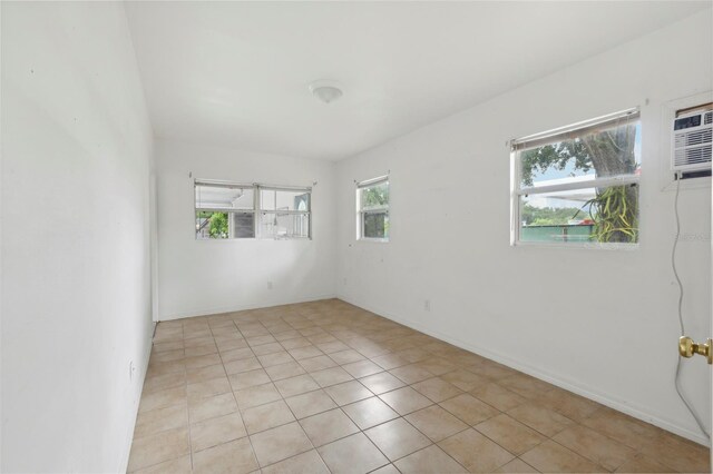 spare room featuring light tile patterned flooring