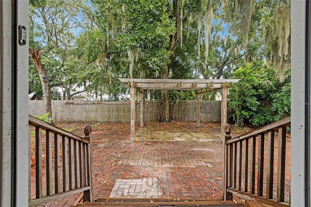 wooden deck featuring a pergola and a patio area