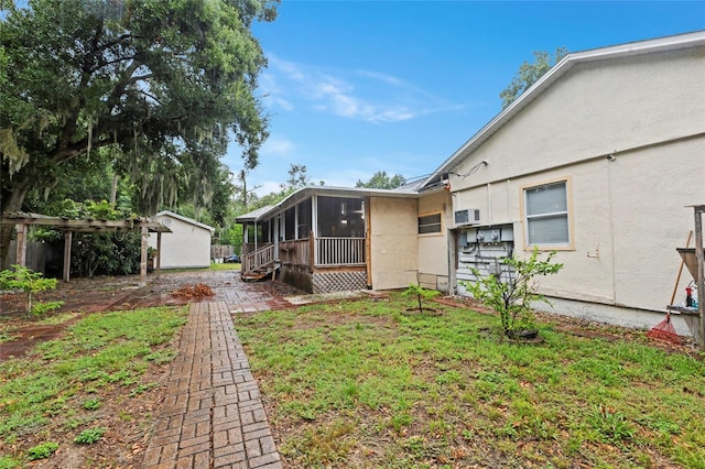 back of house featuring a sunroom