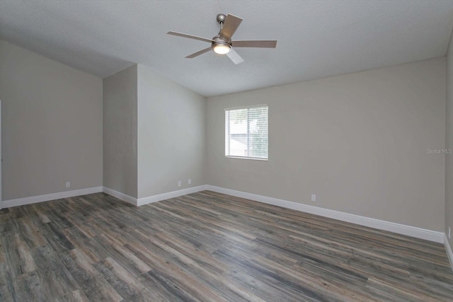 empty room with ceiling fan, dark hardwood / wood-style flooring, and a textured ceiling