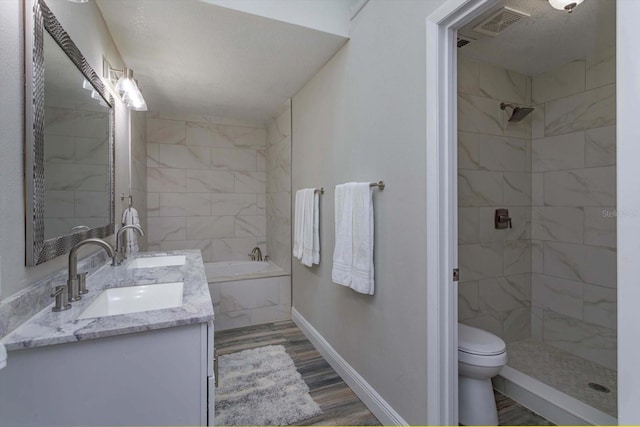 full bathroom with vanity, toilet, hardwood / wood-style floors, and shower with separate bathtub