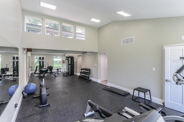 workout area featuring high vaulted ceiling