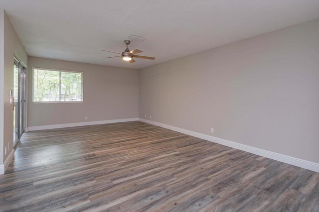 empty room with ceiling fan and hardwood / wood-style flooring