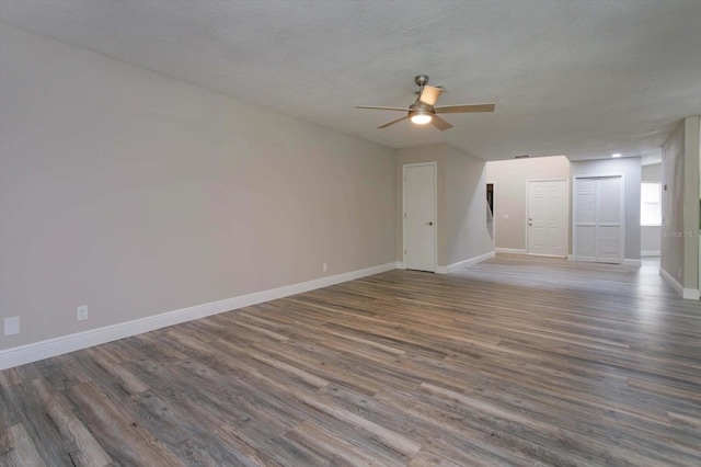 spare room featuring a textured ceiling, ceiling fan, and dark hardwood / wood-style floors