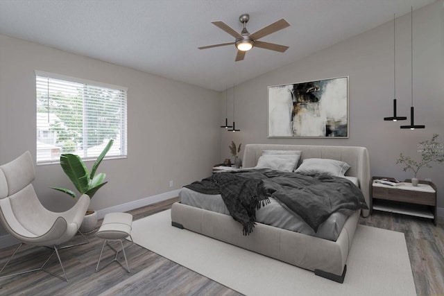 bedroom featuring vaulted ceiling, ceiling fan, and dark hardwood / wood-style floors