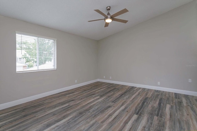 empty room featuring dark wood-type flooring and ceiling fan