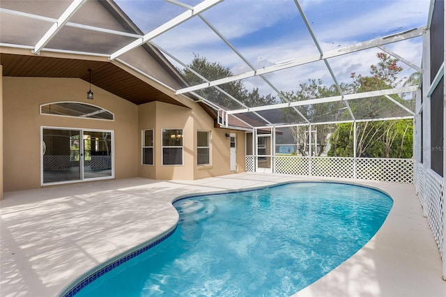 view of pool featuring glass enclosure and a patio area