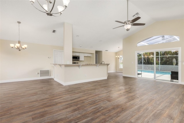 unfurnished living room featuring high vaulted ceiling, ceiling fan with notable chandelier, and hardwood / wood-style floors