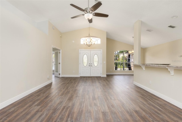 foyer entrance with ceiling fan with notable chandelier, high vaulted ceiling, and dark wood-type flooring