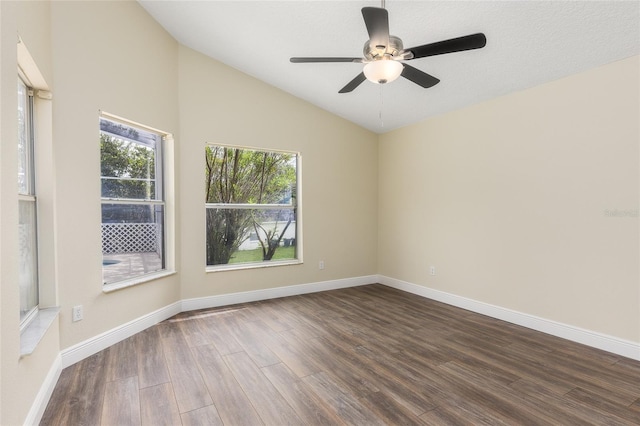 unfurnished room featuring lofted ceiling, hardwood / wood-style floors, and a healthy amount of sunlight