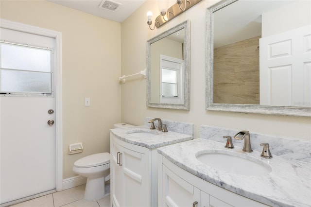 bathroom featuring tile patterned flooring, toilet, and vanity